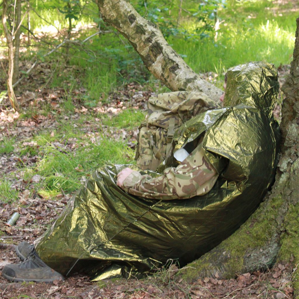 Military personnel using the Military hypothermia poncho